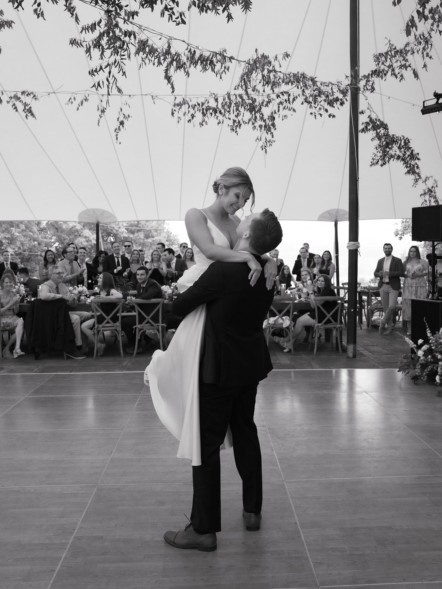 groom twirls bride around on floor at the Buttermilk Inn &amp; Spa