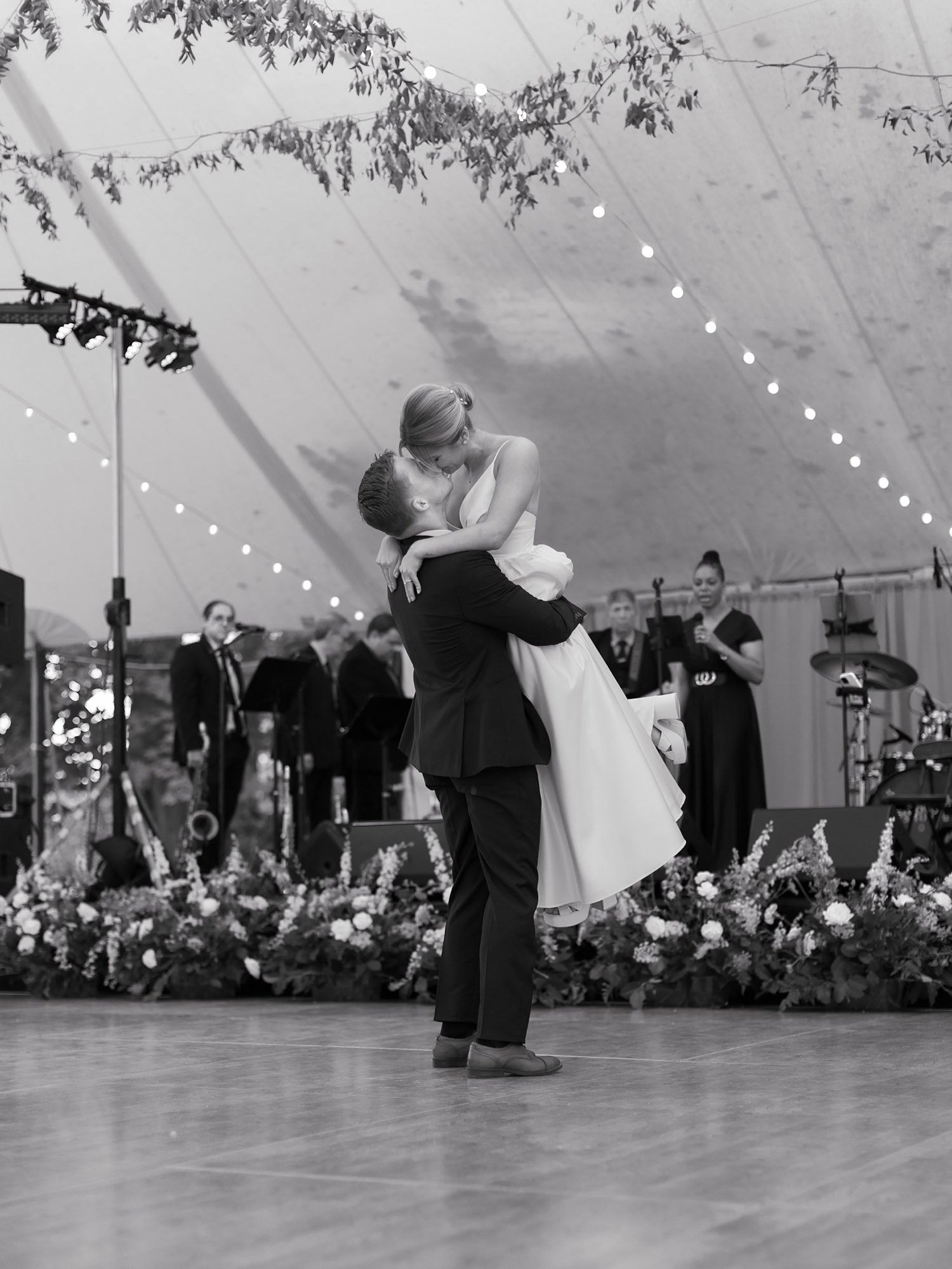 groom lifts up bride on dance floor at the Buttermilk Inn &amp; Spa