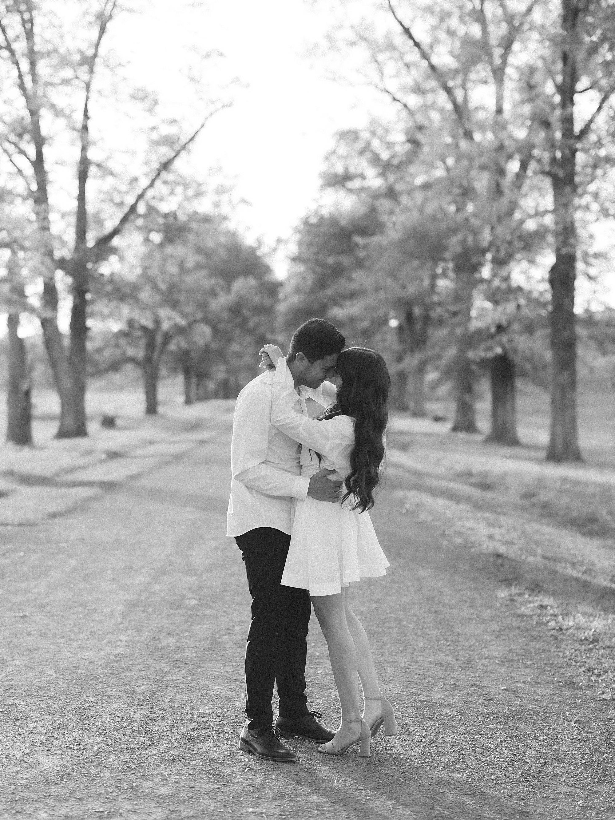 man and woman hug on pathway inside Testimonial Gateway Park