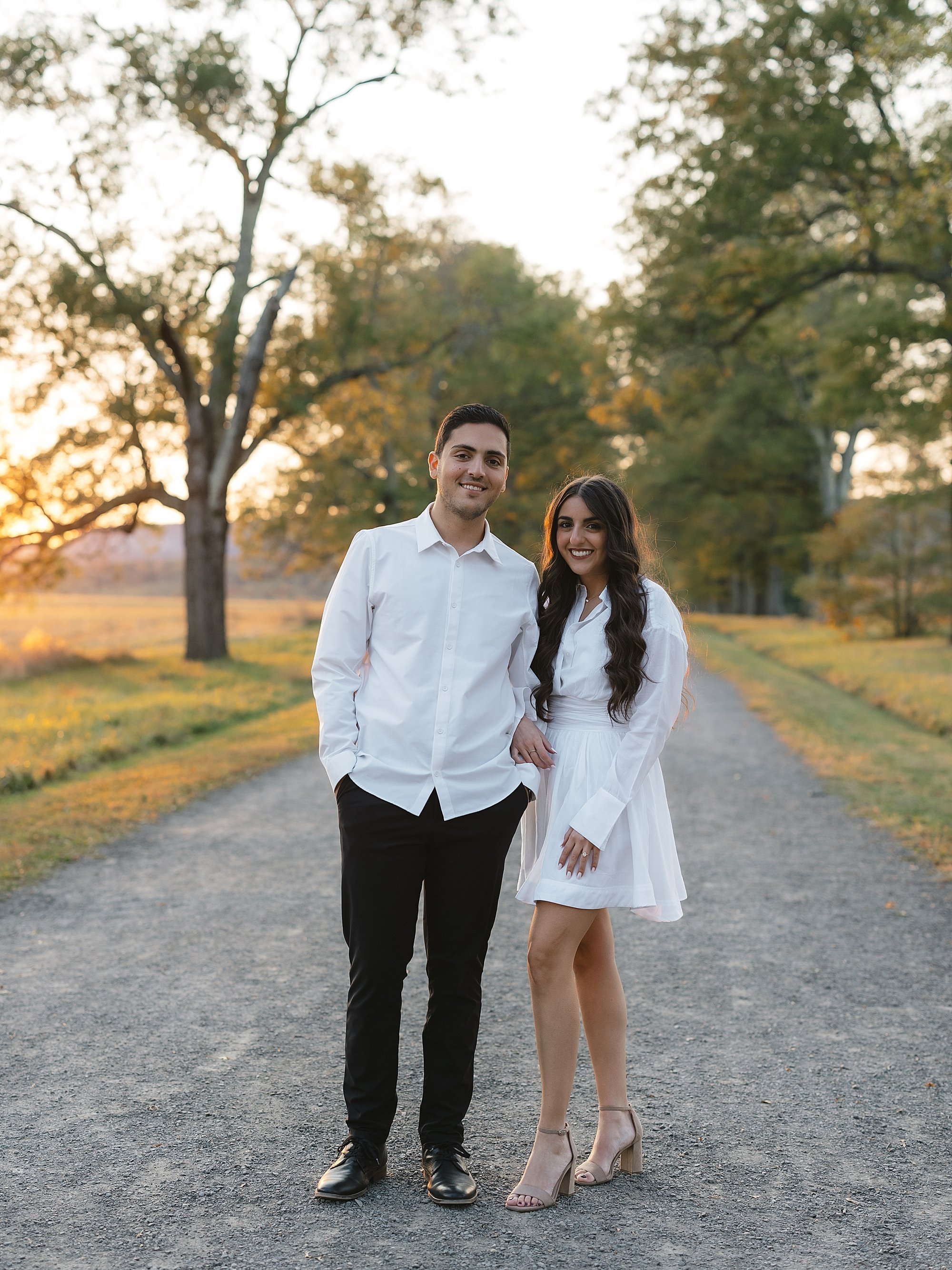 man and woman hold hands standing together in driveway at Testimonial Gateway Park