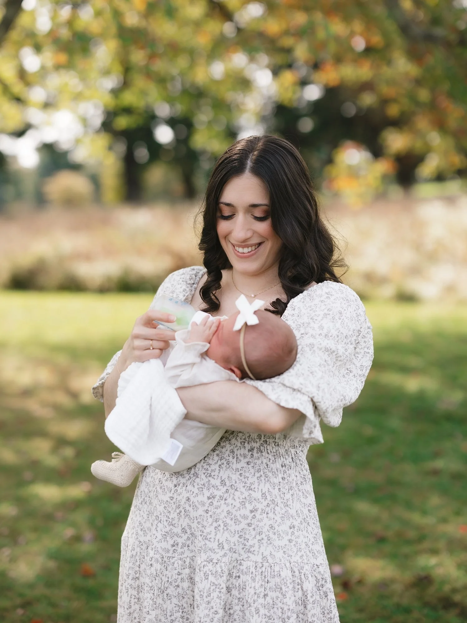 woman holds daughter during Topsmead State Forest family portraits with Westchester family photographer