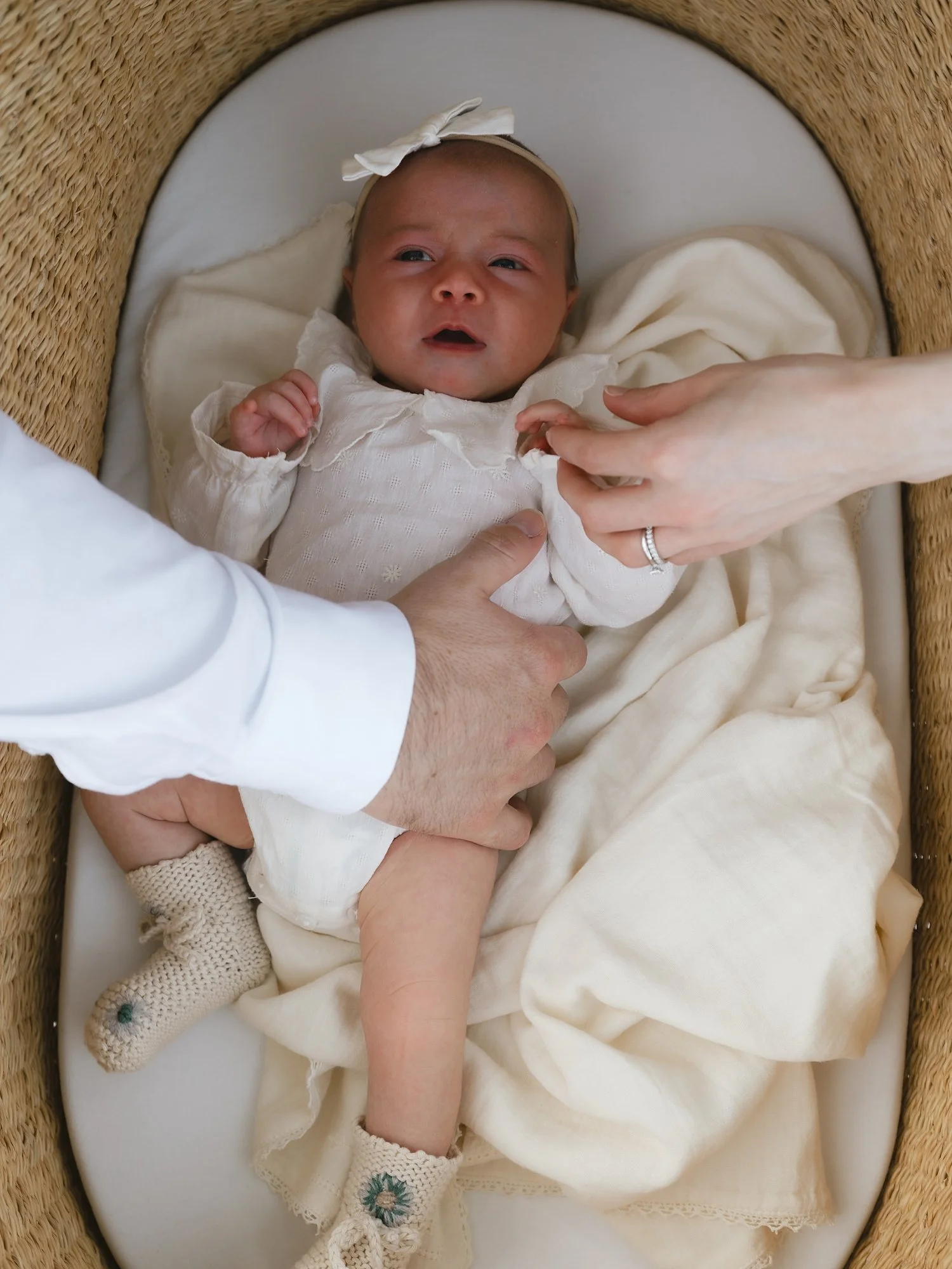 baby cries in Moses basket during photos