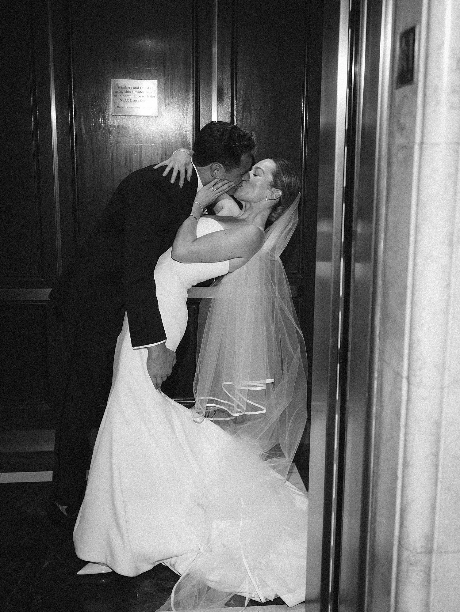 newlyweds kiss in elevator at the New York Athletic Club