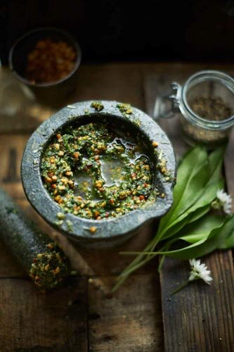 WILD GARLIC PESTO ON WOOD IN A PESTLE AND MORTAR