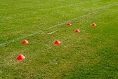 27724747-soccer-football-training-cones-for-marking-on-the-field-grass.jpg