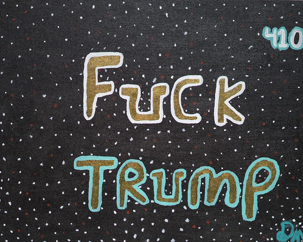 Black fabric with colorful embroidered text saying 'FUCK TRUMP' and a small blue number '410' in the top right corner.