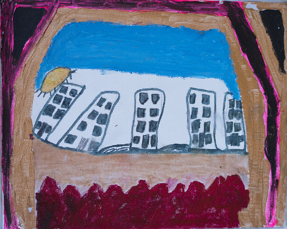 Child's drawing of a cityscape with tall buildings, a sun in the top left corner, a blue sky, and a red ground at the bottom, framed by pink and black borders.