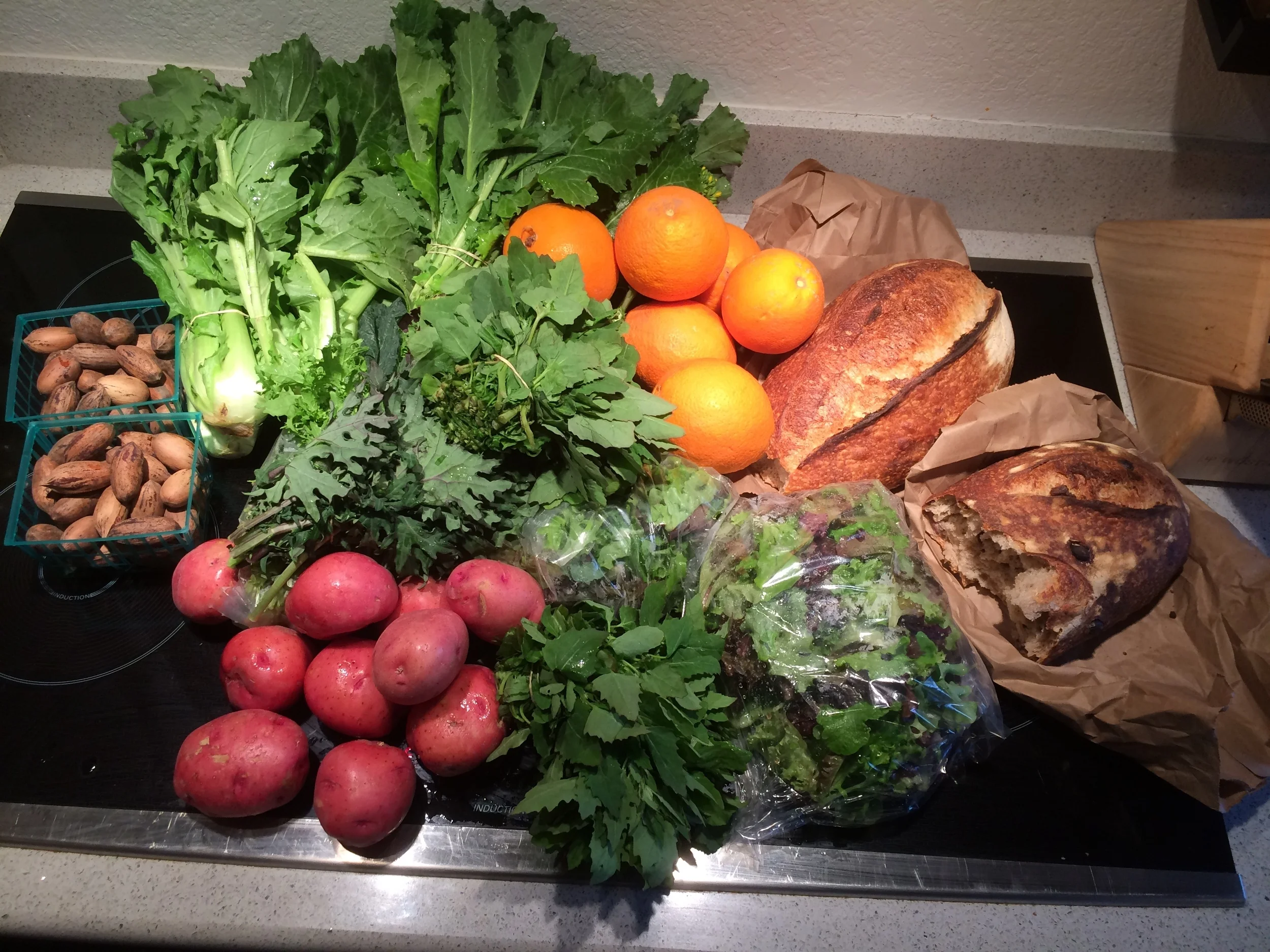One of our week's share at the CSA - Tons of greens at this time of year. The Bario Bread, which is a part of our share is also delicious! 