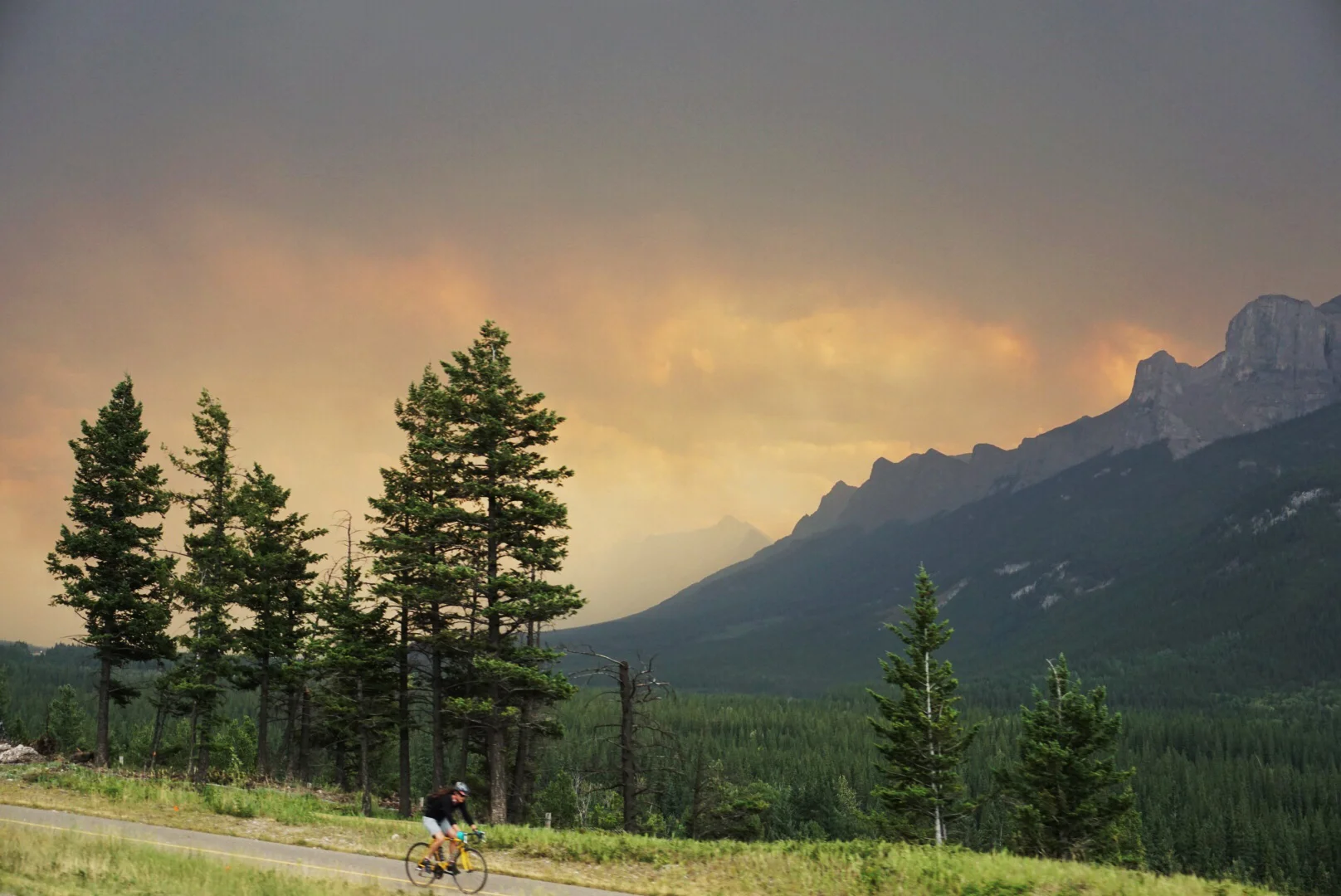 Smokey skies as we drove into Canmore, AB. I just love the colors on this pic. I took it from the car as we were driving and that cyclist timed himself perfectly to get in the shot :) 