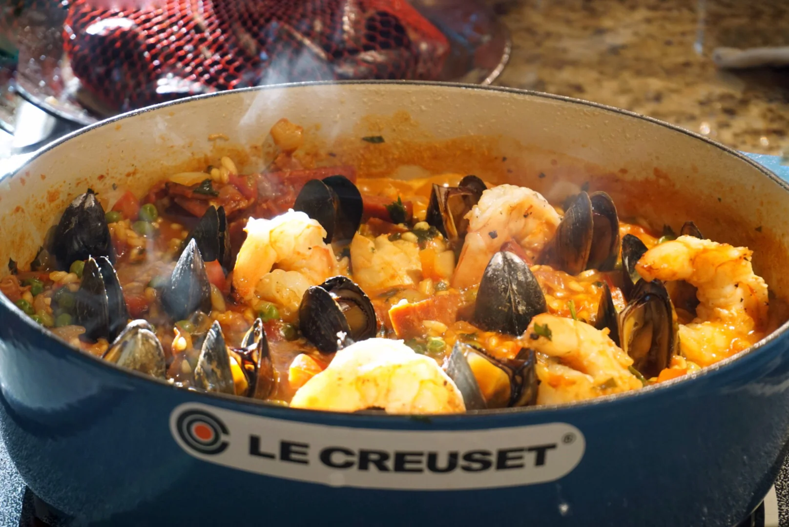 Some mussels are swimming in the paella while the other ones are waiting their turn in the background. I annoyed David all summer about making a Paella... After the MSA World Cup, I took a week off and we finally made it. It was delicious and a…