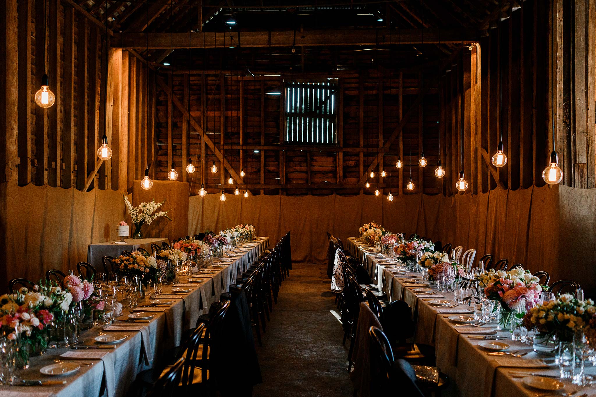  Brickendon barn set for intimate dining with custom lighting 