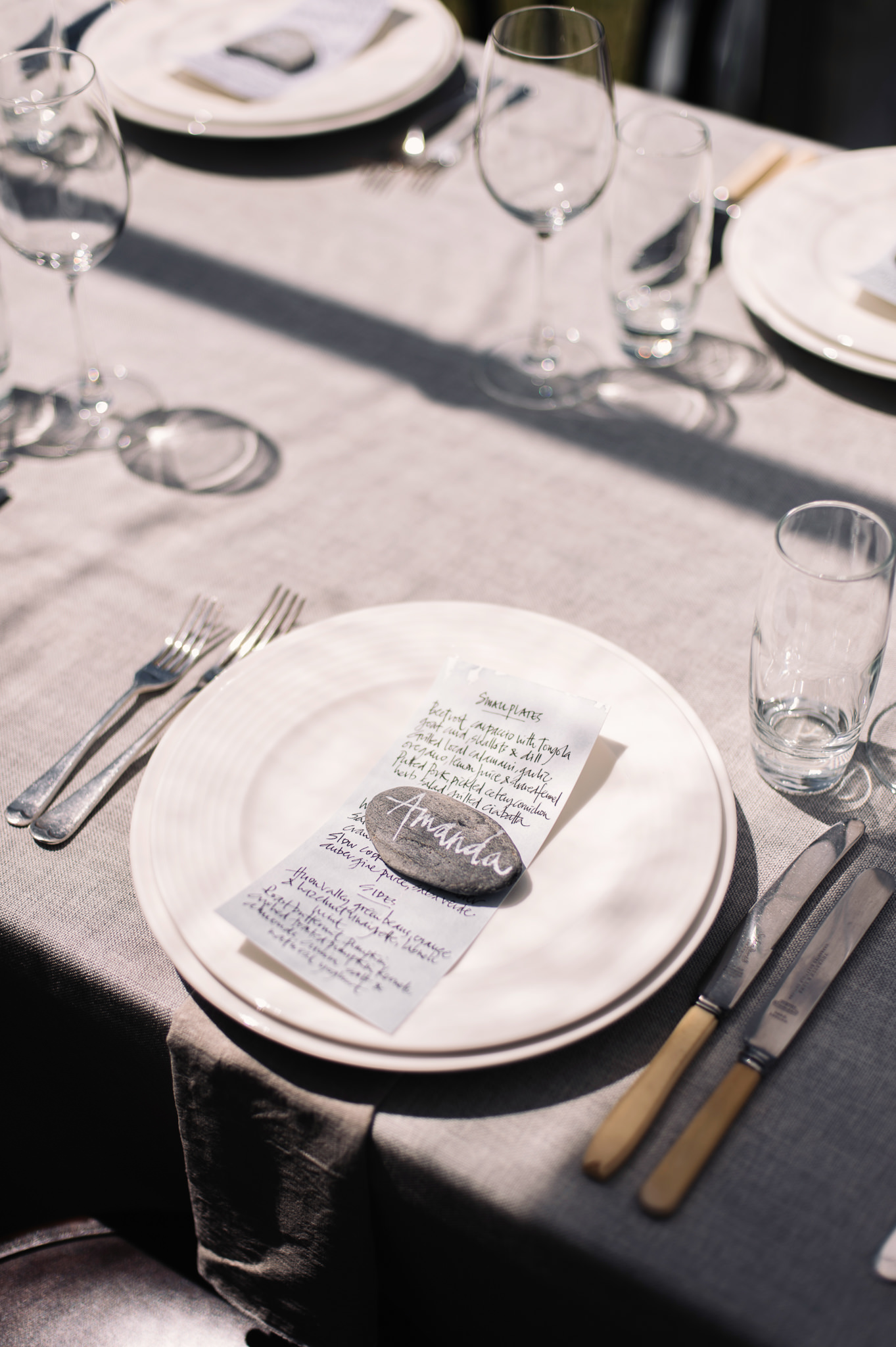  Guests names hand written on rocks sourced from the local beaches 