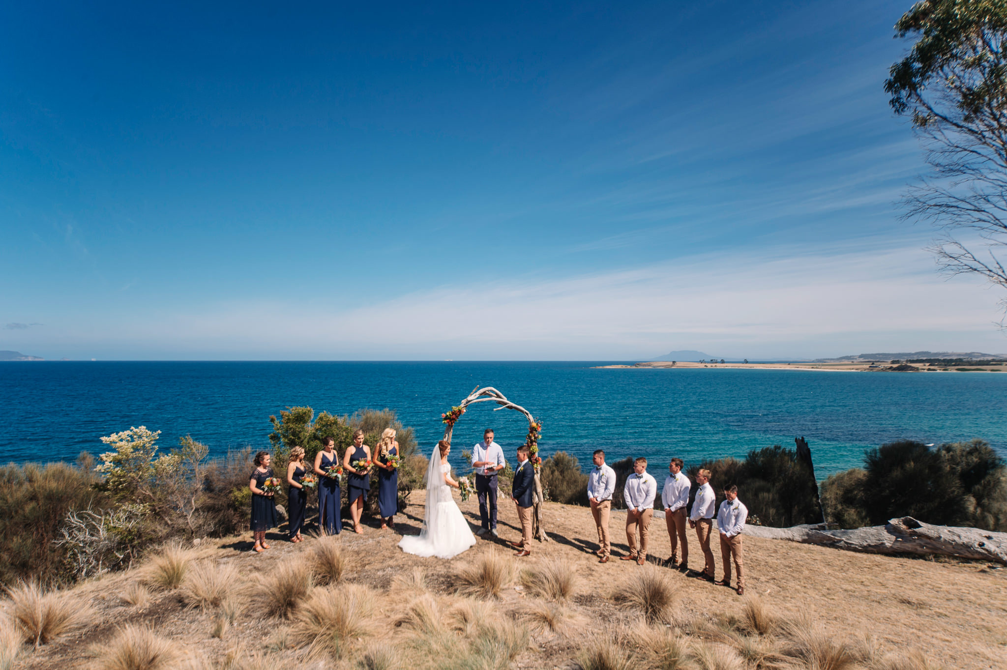  Wedding Ceremony under a driftwood arch at Avalon Coastal retreat 