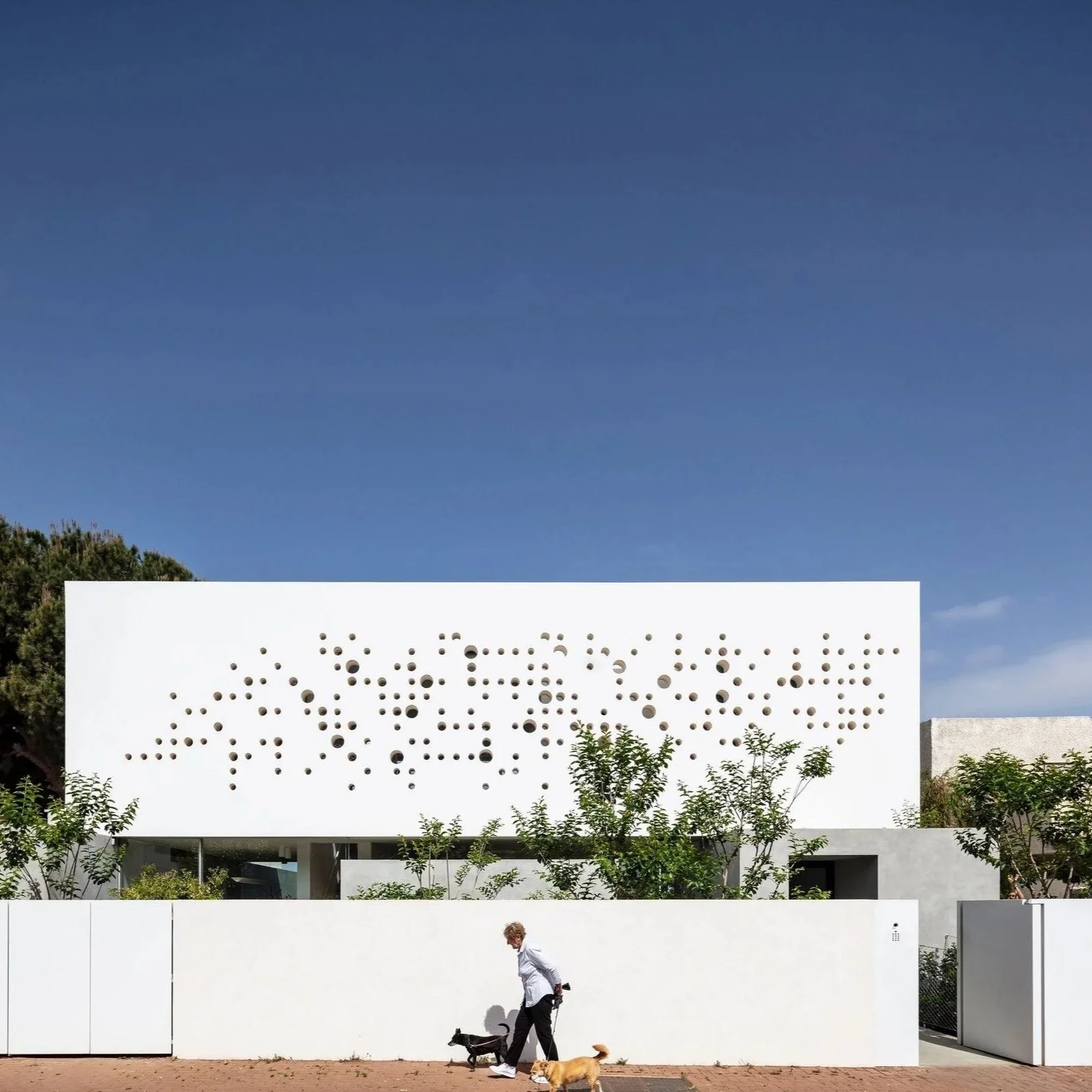 Archello: Round Edge House. An Anderman Architects residence shaped by a perforated concrete envelope that filters light while preserving privacy and openness.