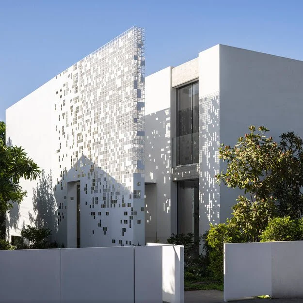 Archello: Pixel House. An Anderman Architects residence in Tel Aviv, wrapped by a pixelated metal screen that shifts between enclosure, transparency and shadow.