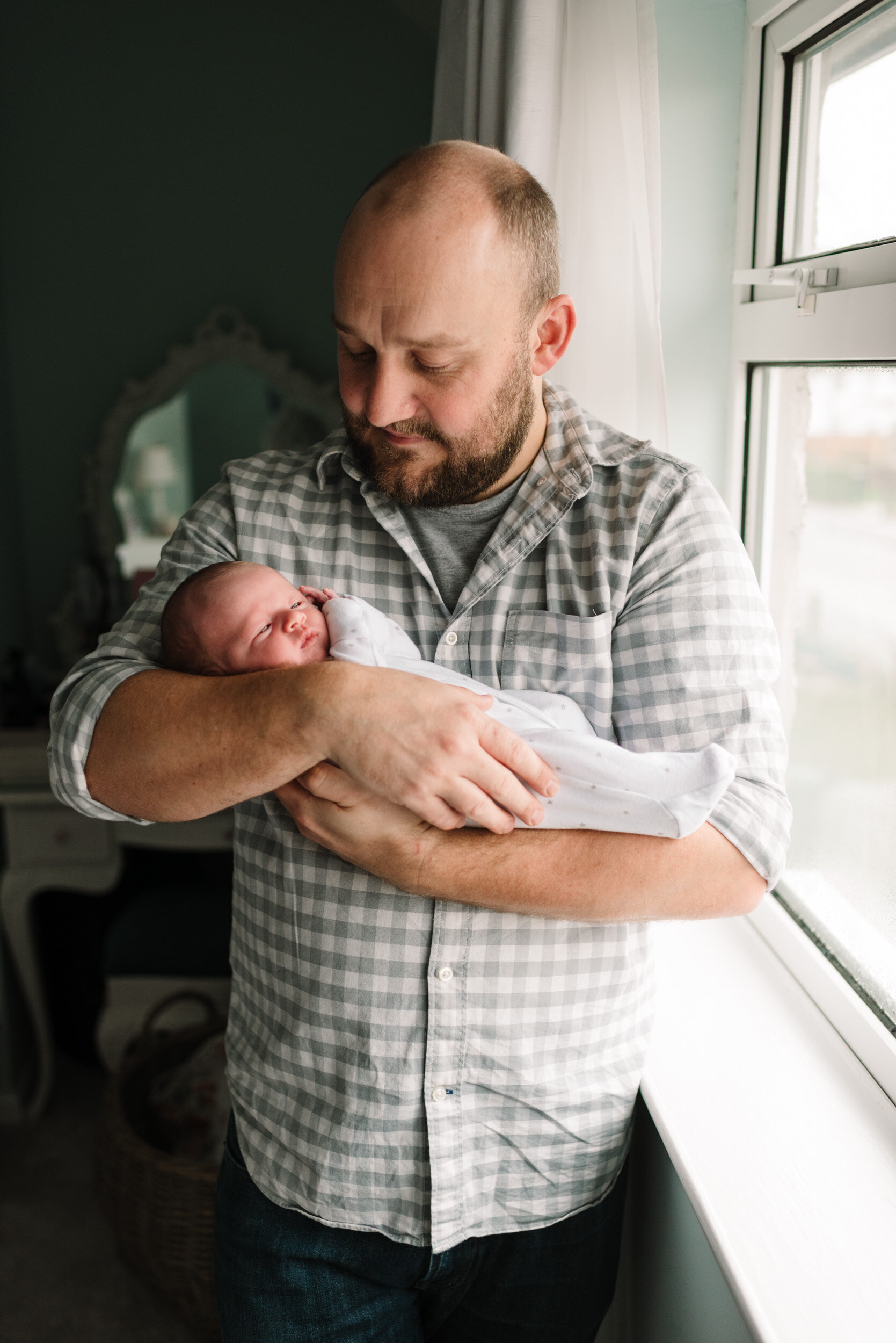 Proud dad holding newborn baby