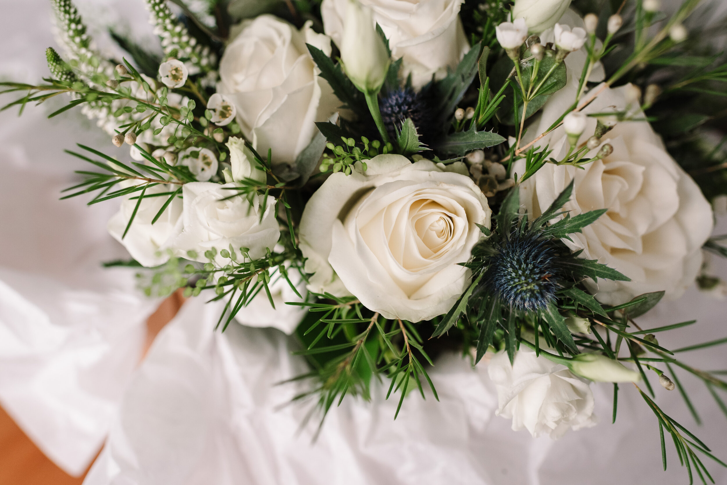 Bride's bouquet with white roses and thistles