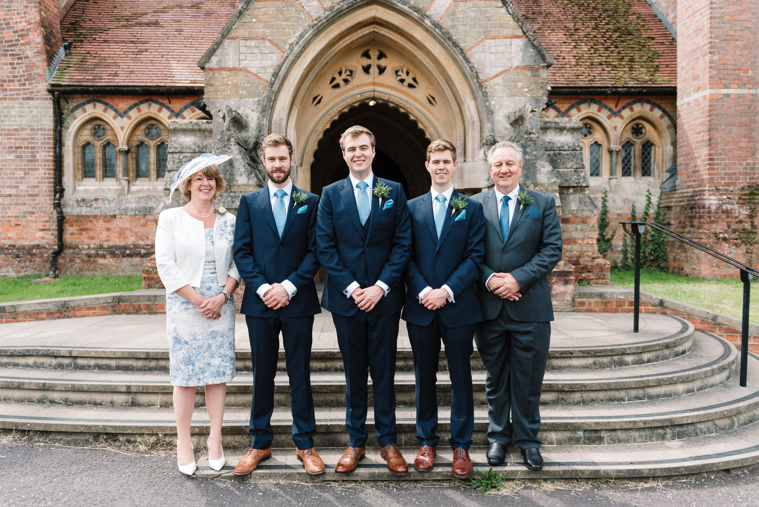 Groom, his parents and two brothers outside a church