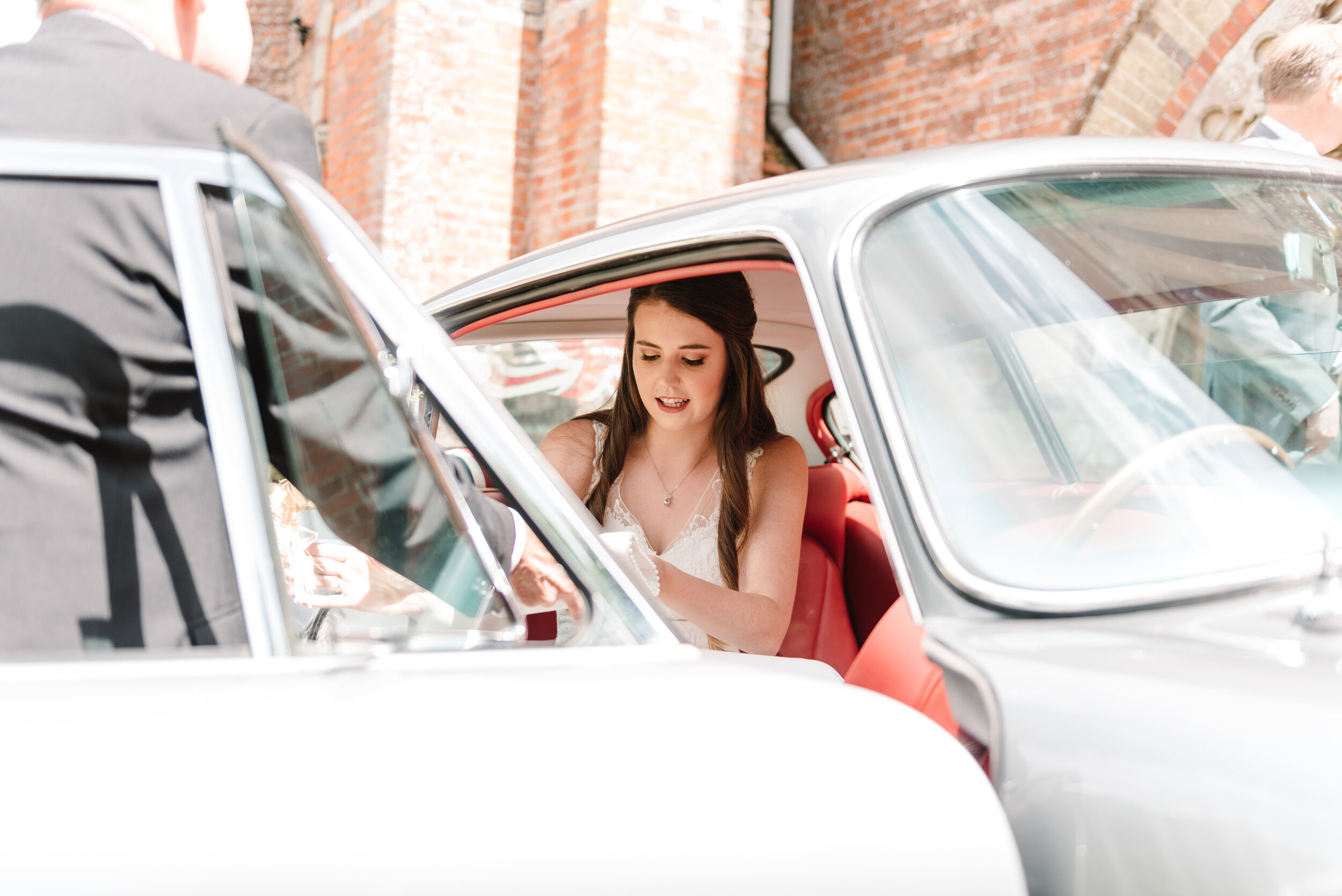 Bride getting out of Aston Martin DB5