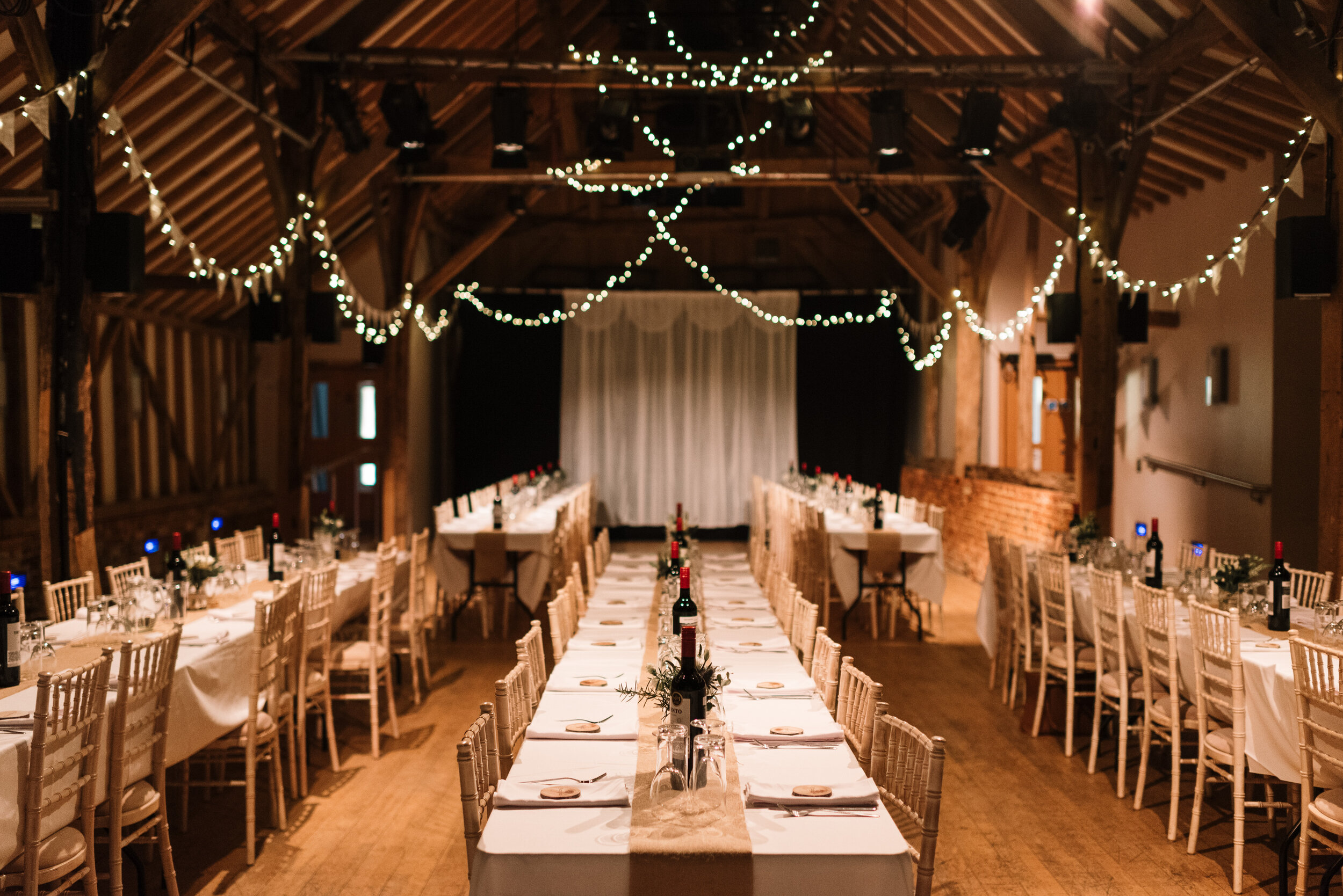 Wedding breakfast tables set out in banquet style at Hanger Farm near Southampton