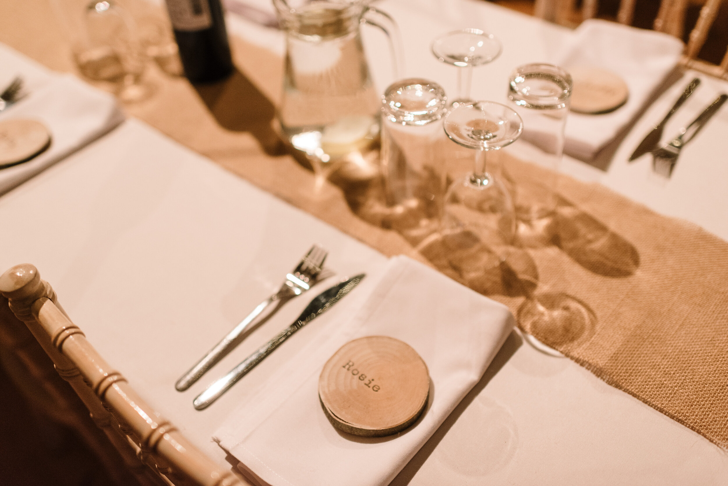 Place setting at wedding with wooden name tag