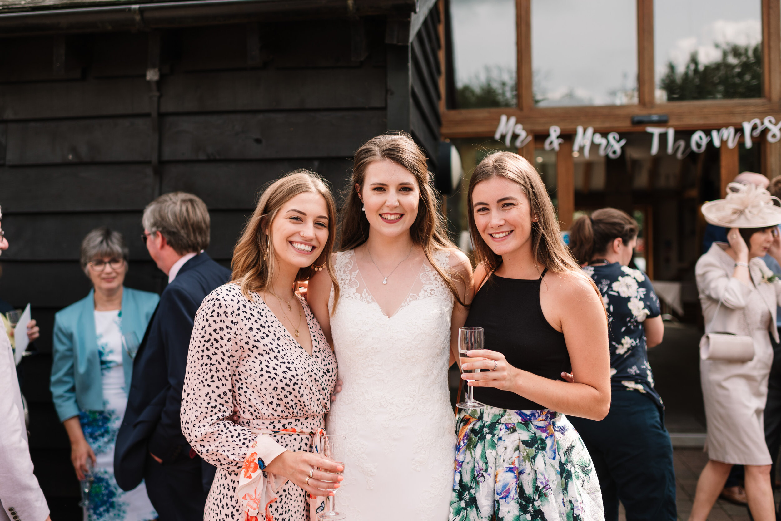 Bride and two friends posing for photo at Hanger Farm wedding venue