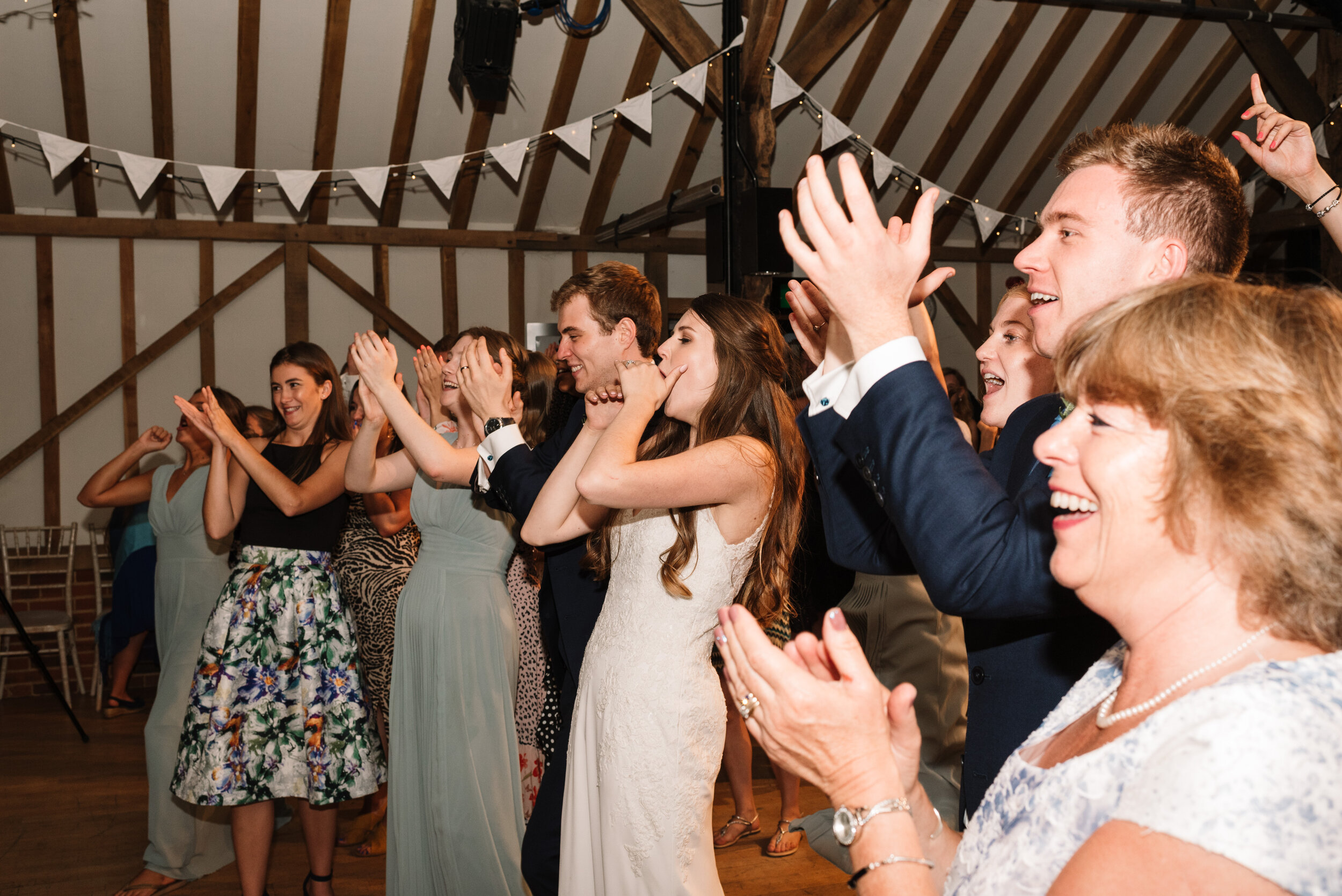Bride and groom clapping for wedding band at Hanger Farm