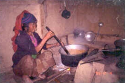 Nepali woman cooking soybeans to make kinema