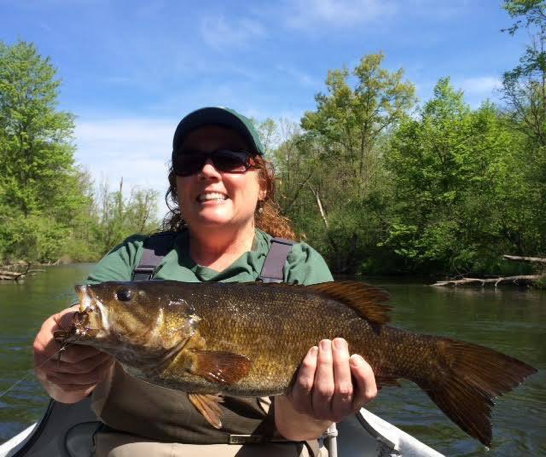 Photo: Fly Factor client Suzanne Stone with her largest smallie to date, a beautiful 19” fish. She caught it in late May 2016. This fish took a weighted crayfish streamer (Skyes craw) developed by Skye Fissette, same as above, tied by Brett.