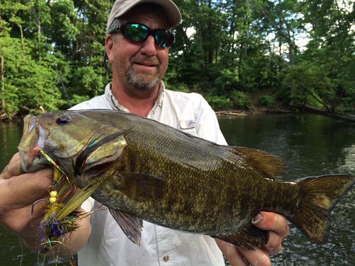 Photo : Fly Factor client Shane Snyder with an 18” post-spawn June 2016 smallie that ate a large neutrally buoyant streamer (D & D). Big fly and a big meal for a hungry top-notch predator.