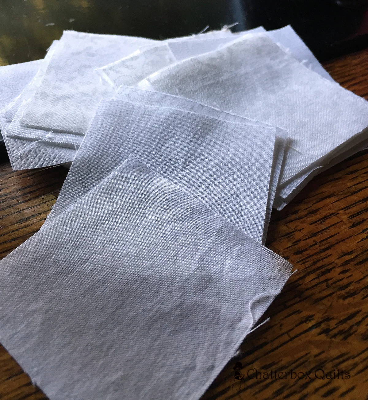 White squares ready to be stitching in between the fabric strips