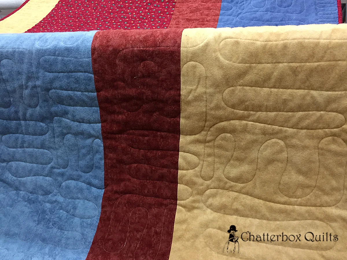 Details of quilting on pieced flannel back