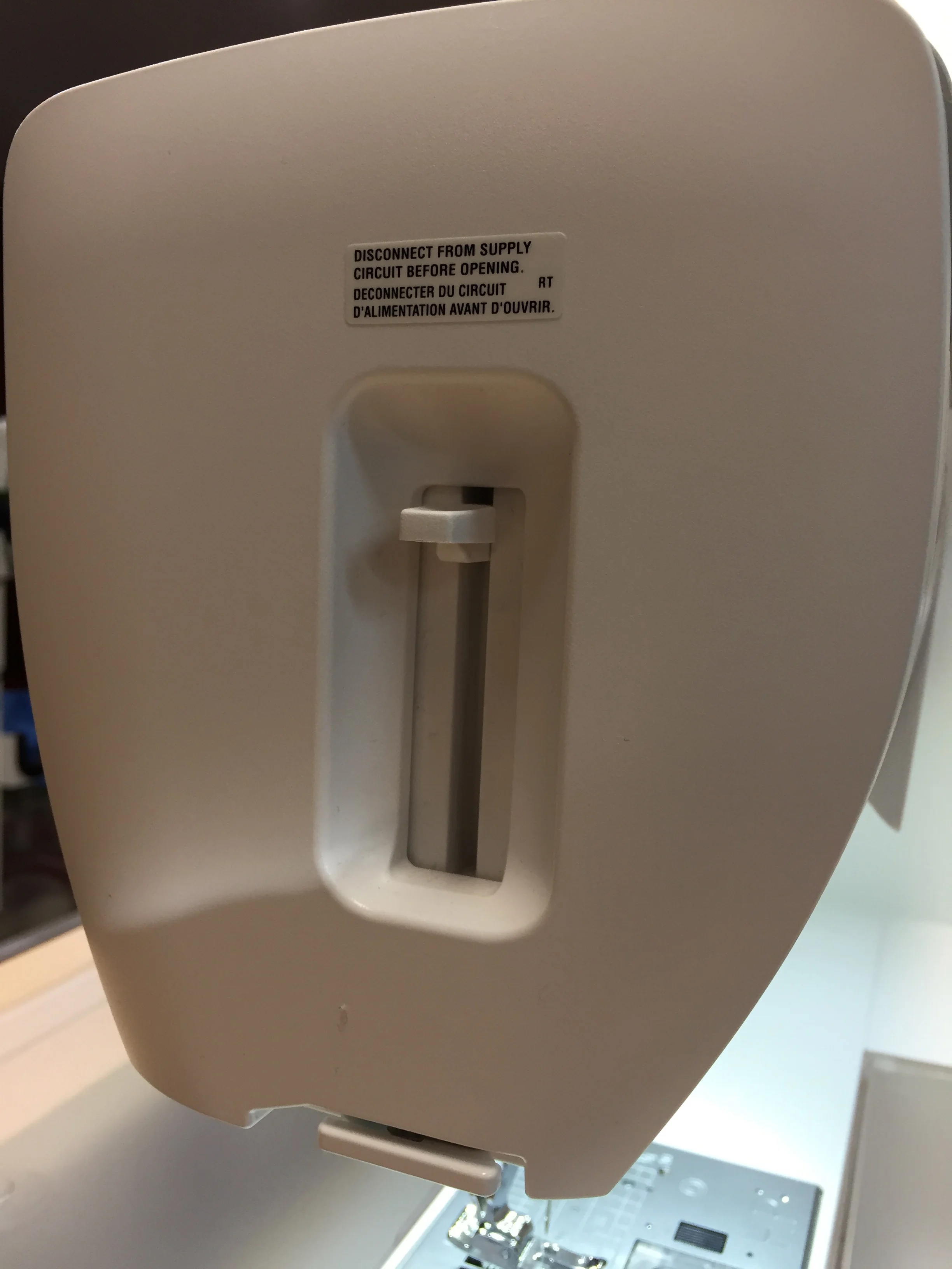 Press down on the lever at the left hand side of the machine