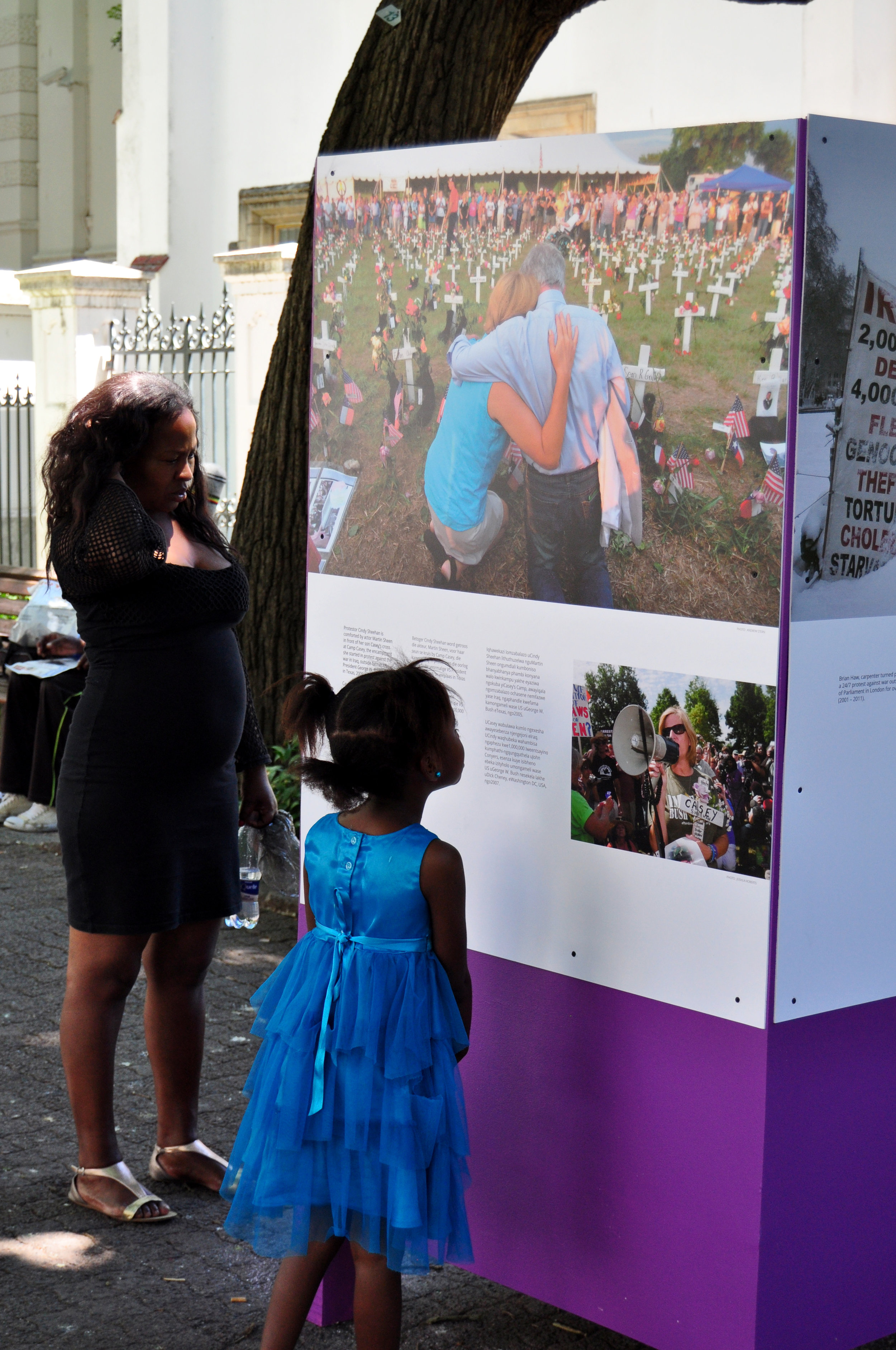 A young girl stops to read one of the exhibition pieces.
