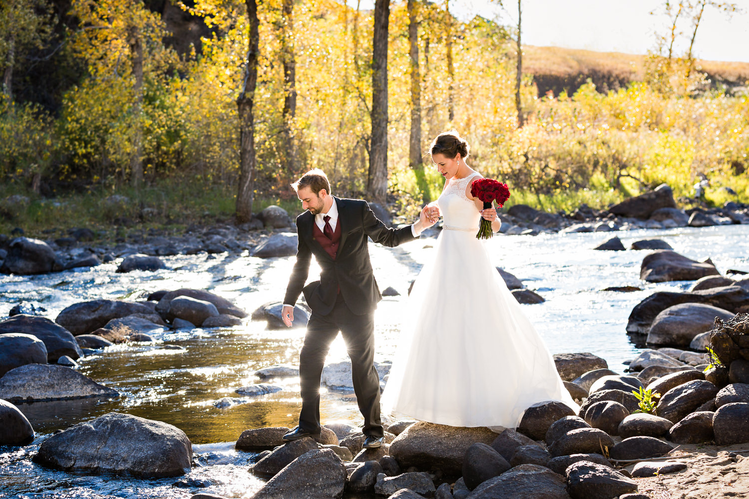 absaroka-beartooth-wilderness-montana-wedding-reception-couple-crossing-river.jpg