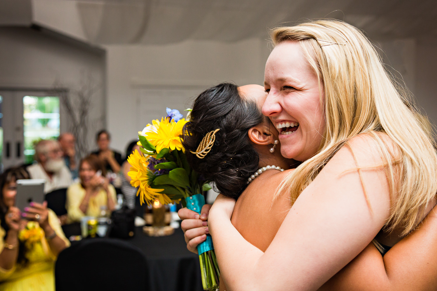 billings-montana-chanceys-wedding-reception-bride-hugs-bouquet-catcher.jpg
