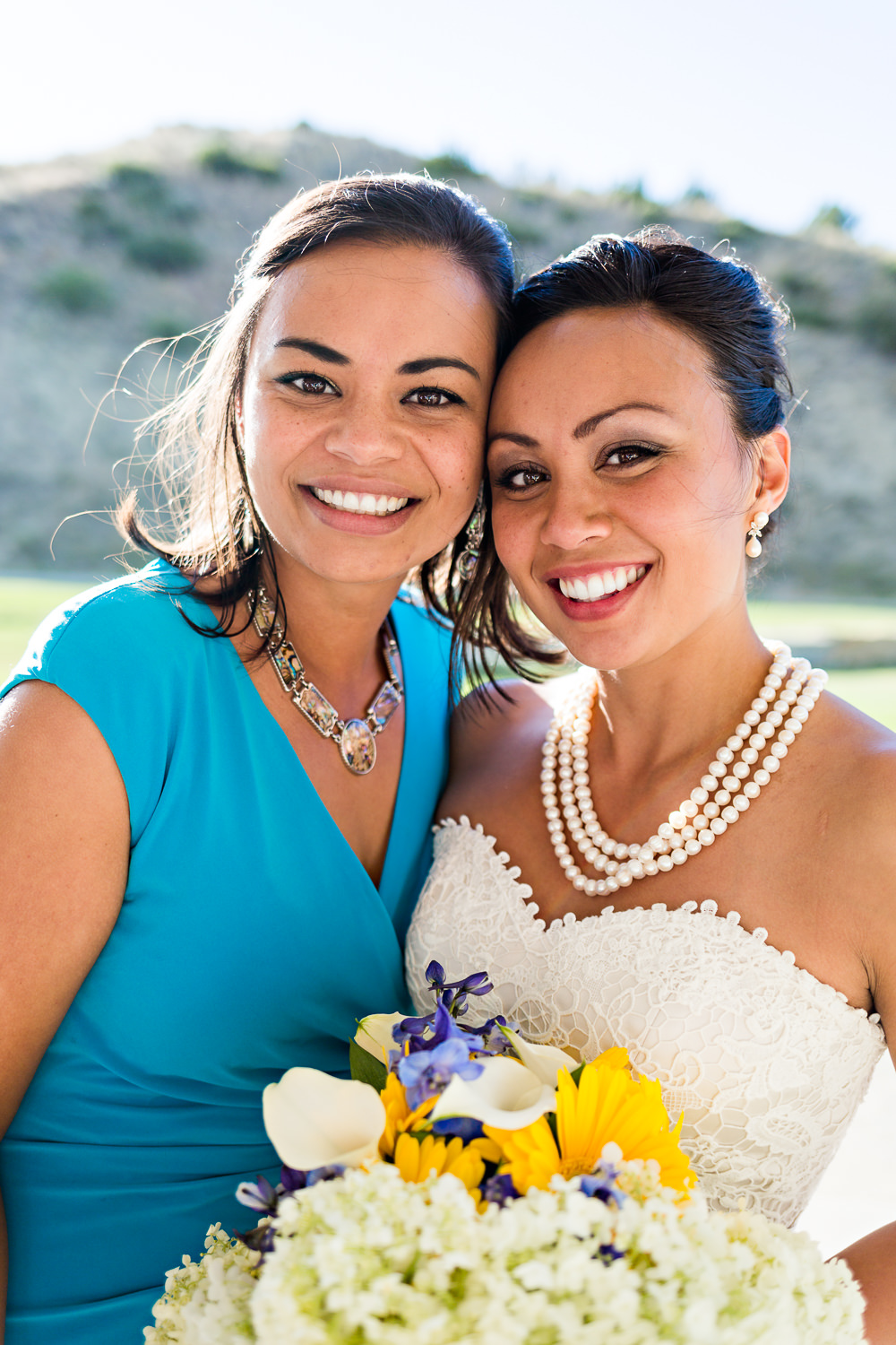 billings-montana-chanceys-wedding-reception-bride-hugs-sister.jpg