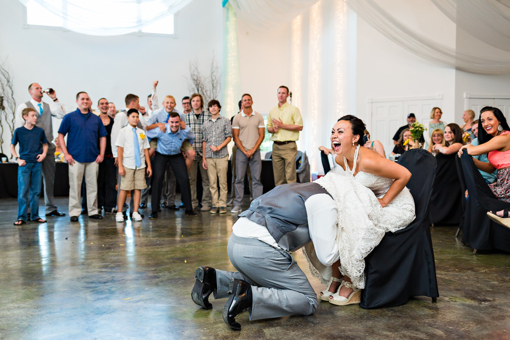 billings-montana-chanceys-wedding-reception-groom-retrieves-garter.jpg