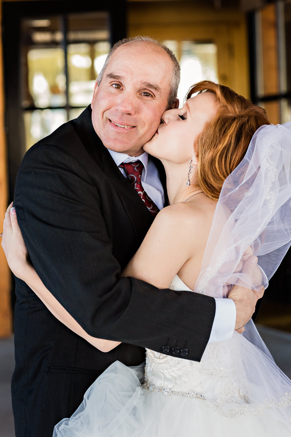 big-sky-montana-winter-wedding-breanna-father-first-look-bride-kisses-dad.jpg