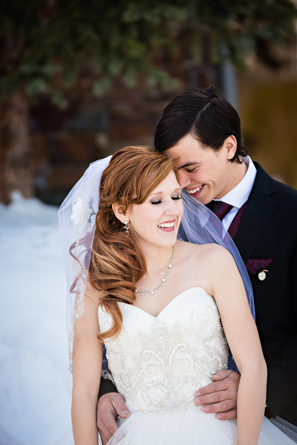 big-sky-montana-winter-wedding-breanna-first-look-groom-leans-against-bride.jpg