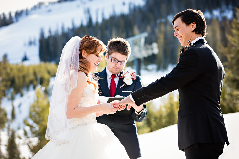 big-sky-montana-winter-wedding-breanna-ceremony-bride-exchanges-rings.jpg