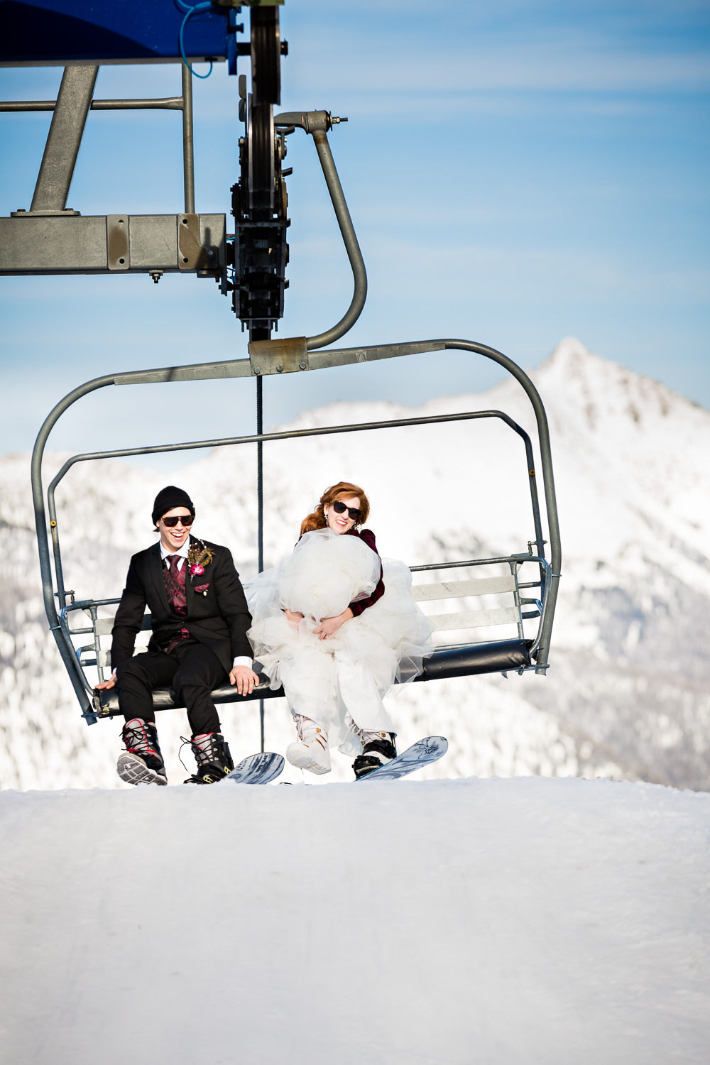 big-sky-montana-winter-wedding-breanna-formals-bride-groom-unload-chairlift.jpg