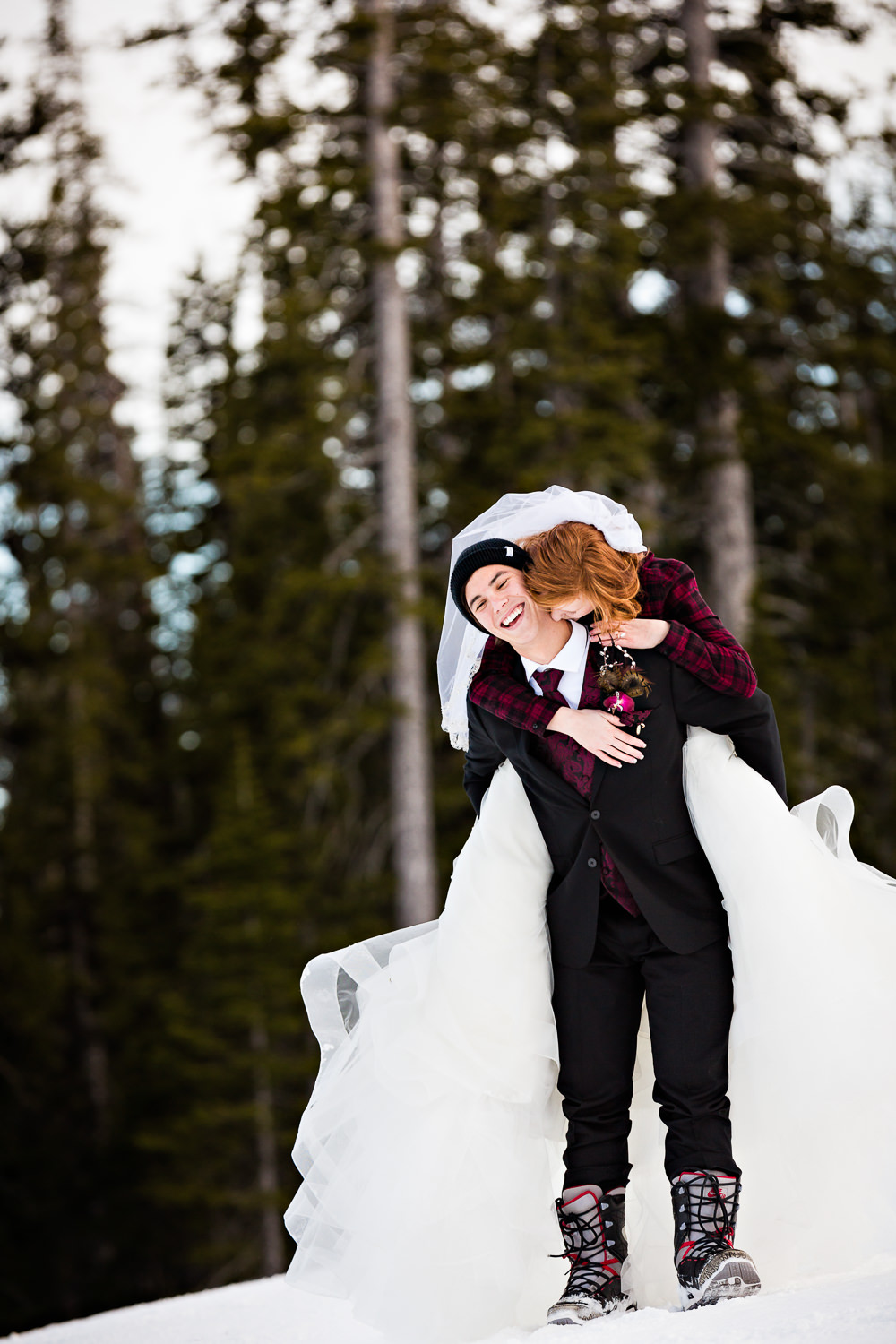 big-sky-montana-winter-wedding-breanna-formals-bride-jumps-on-grooms-back.jpg