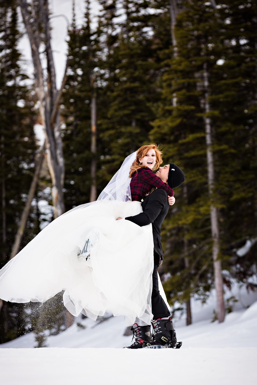 big-sky-montana-winter-wedding-breanna-formals-groom-lifts-bride.jpg