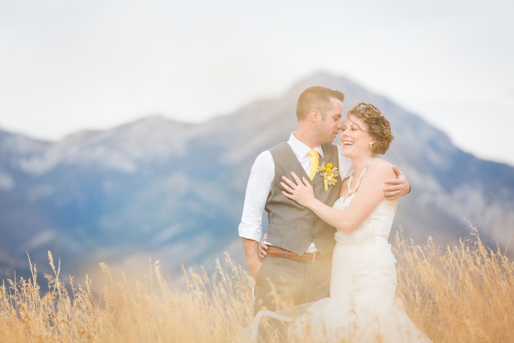 bozeman-wedding-big-yellow-barn-couple-laughing-near-bridger-mountains.jpg