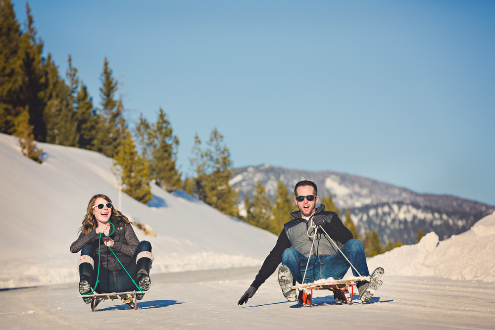 big-sky-montana-winter-engagement-session-couple-goes-sledding.jpg