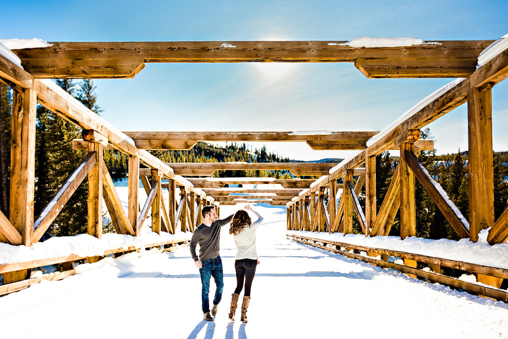big-sky-montana-winter-engagement-session-couple-dancing-on-bridge.jpg