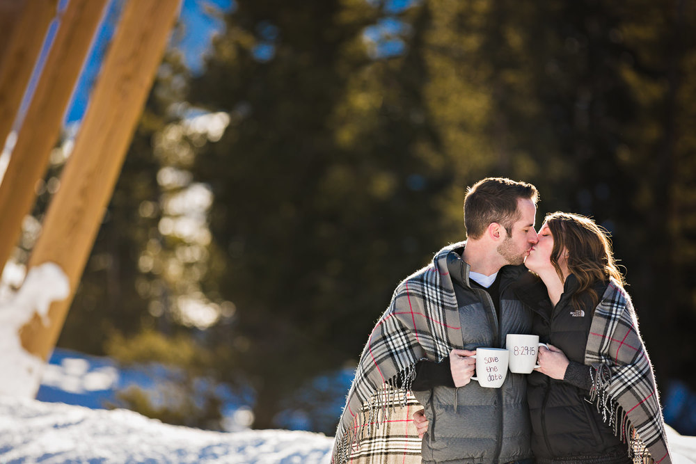 big-sky-montana-winter-engagement-session-couple-kissing-save-date-mugs.jpg