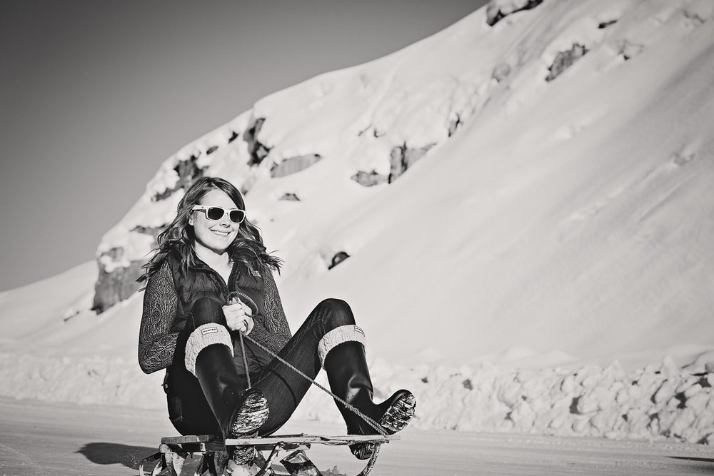 big-sky-montana-winter-engagement-session-woman-sleds.jpg