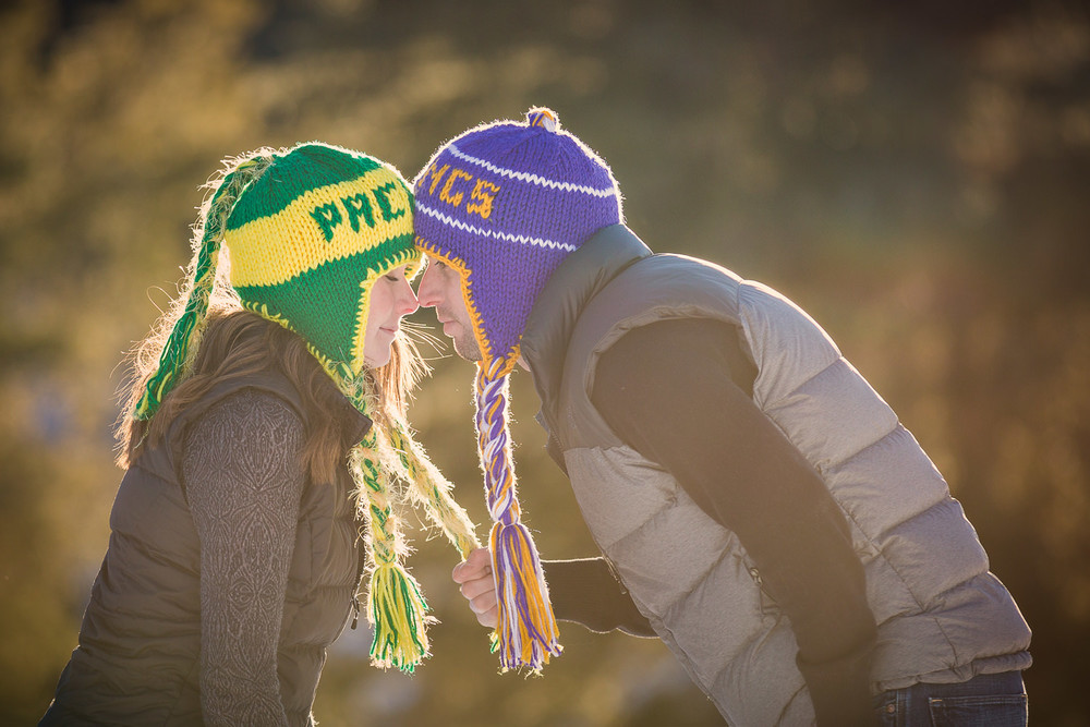 big-sky-montana-winter-engagement-session-man-tugs-on-womans-hat.jpg